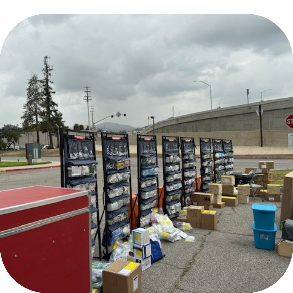 Upright Medical Organizers (UMO) staged outside with boxes of medical supplies during a supply replenishment service