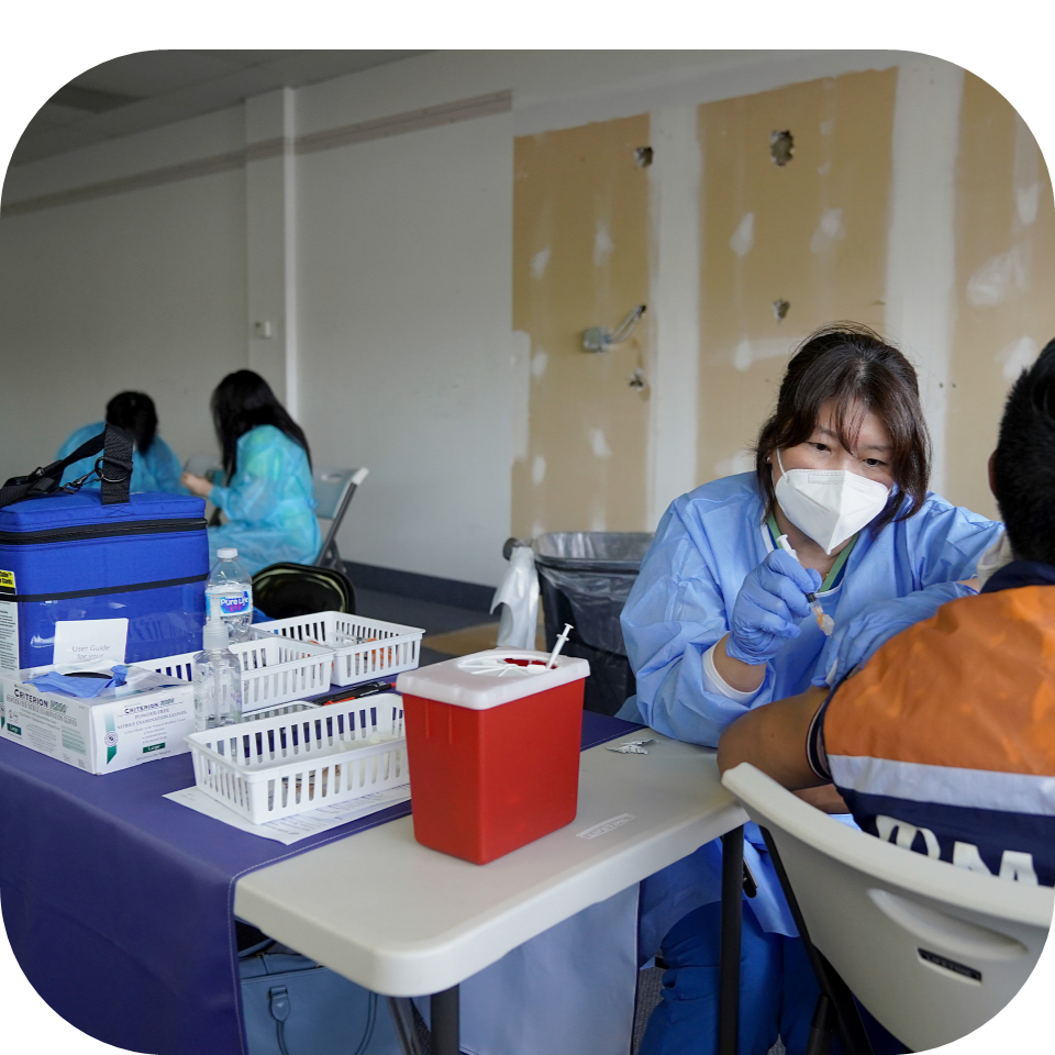 Cool Cube sitting on a table while a nurse is giving a vaccination to a patient