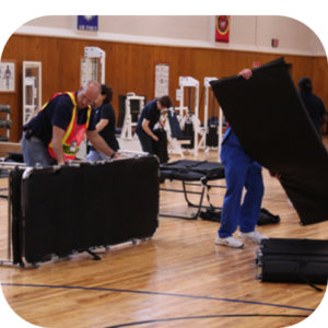 Healthcare workers setting up an alternate care site