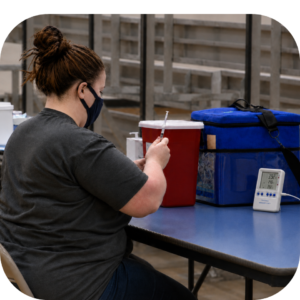 Nurse using cool cube medical cooler for vaccine transport